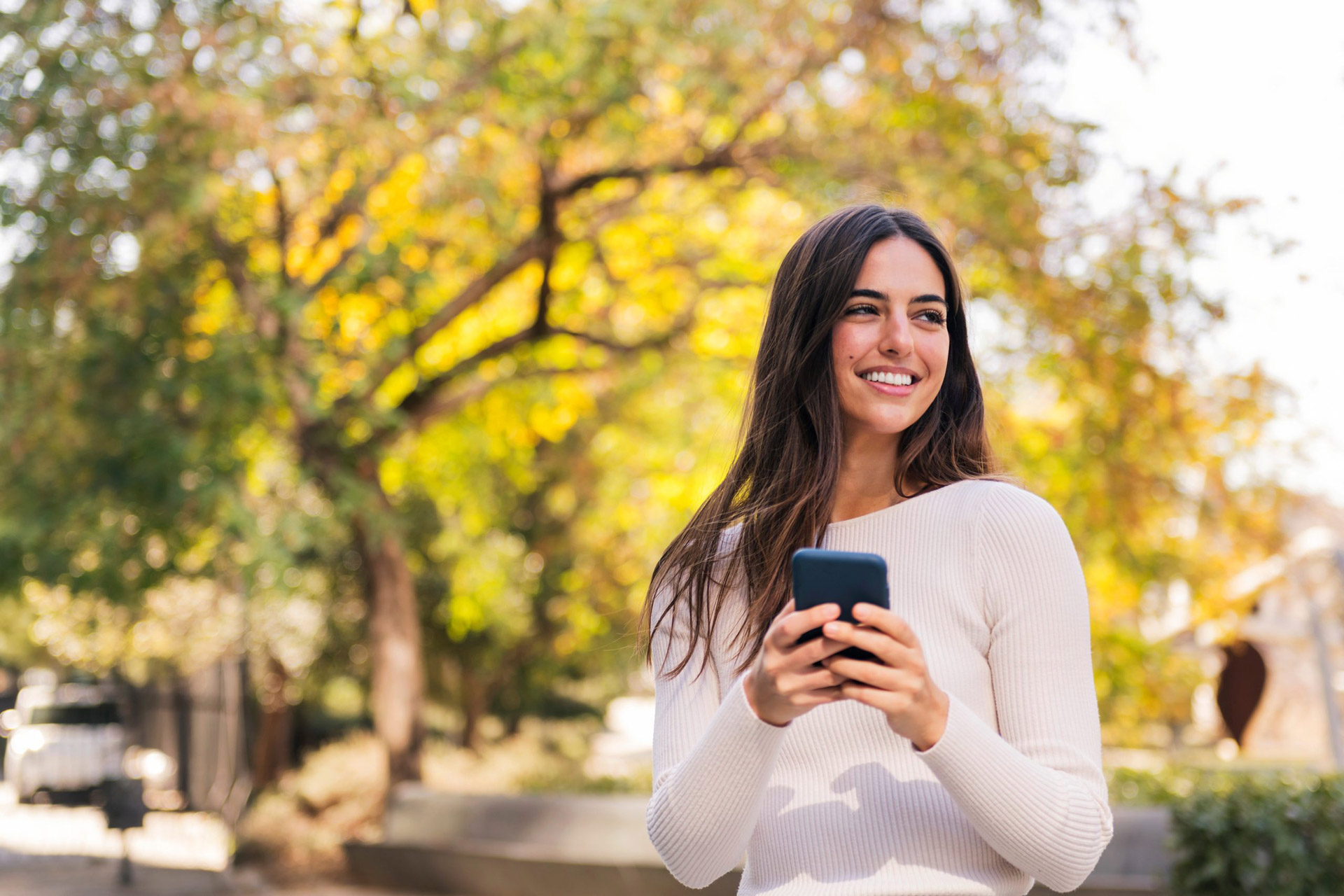 woman outside with phone